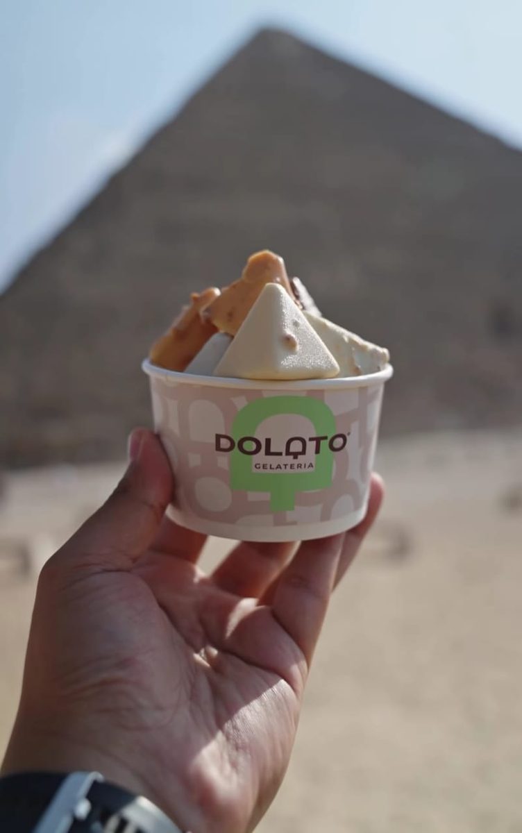 Dolato gelato cup held in front of the Pyramids